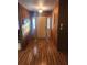 Inviting entryway features wood paneling, hardwood floors, and classic lighting fixture at 2151 Se 177Th Ave, Silver Springs, FL 34488