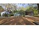 View of detached garages and carport with mature foliage at 2151 Se 177Th Ave, Silver Springs, FL 34488