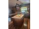 Traditional kitchen with a center island, wood cabinets, and a large window at 2151 Se 177Th Ave, Silver Springs, FL 34488