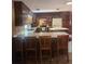 A well-equipped kitchen featuring wood cabinets, an island with barstool seating, and modern appliances at 2151 Se 177Th Ave, Silver Springs, FL 34488