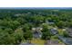 An aerial showcases the home among many trees in a quiet neighborhood at 2272 Se Laurel Run Dr, Ocala, FL 34471