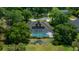 An aerial view showcases a private pool, screened-in patio, and a small pond feature at 2272 Se Laurel Run Dr, Ocala, FL 34471