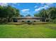 A serene backyard is complemented by a screened lanai and small pond feature at 2272 Se Laurel Run Dr, Ocala, FL 34471