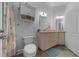 Updated bathroom with a toilet, double sinks, white cabinets, and tile floors at 2272 Se Laurel Run Dr, Ocala, FL 34471