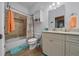 Well-lit bathroom featuring a shower and tub with tiled backsplash and a vanity with white cabinets at 2272 Se Laurel Run Dr, Ocala, FL 34471