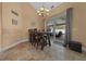 Dining room with tile flooring, dining table with seating for eight, and sliding glass doors to outdoor lanai at 2272 Se Laurel Run Dr, Ocala, FL 34471