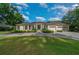 Inviting home exterior featuring a manicured lawn and a three-car garage at 2272 Se Laurel Run Dr, Ocala, FL 34471