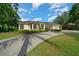 Well-maintained home featuring lush landscaping and a convenient three-car garage at 2272 Se Laurel Run Dr, Ocala, FL 34471