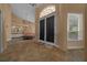 Home foyer featuring neutral walls, tile floors, a large entry door, and a glimpse into an adjacent sitting area at 2272 Se Laurel Run Dr, Ocala, FL 34471