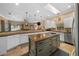 Kitchen featuring a cooktop, white cabinetry, a built in sink, and stainless steel appliances at 2272 Se Laurel Run Dr, Ocala, FL 34471