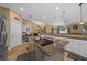 Spacious kitchen with a central island cooktop, white cabinets, and views into the dining and living areas at 2272 Se Laurel Run Dr, Ocala, FL 34471
