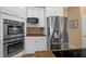 Modern kitchen features stainless steel appliances, granite countertops, and white cabinetry at 2272 Se Laurel Run Dr, Ocala, FL 34471