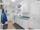 Bright laundry room with plenty of counter and cabinet space, a sink, washer and dryer at 2272 Se Laurel Run Dr, Ocala, FL 34471