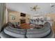 Open living room with a fireplace, hardwood floors, bar seating and comfortable couches at 2272 Se Laurel Run Dr, Ocala, FL 34471