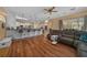 Open floorplan living room with hardwood floors and a breakfast bar into the kitchen at 2272 Se Laurel Run Dr, Ocala, FL 34471