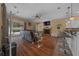 Cozy living room with hardwood floors, a ceiling fan, fireplace and a view to the pool at 2272 Se Laurel Run Dr, Ocala, FL 34471