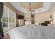 A large main bedroom suite with a ceiling fan, views of the pool, and neutral paint at 2272 Se Laurel Run Dr, Ocala, FL 34471