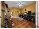 Home office with lots of natural light, hardwood floors and an adjacent bathroom with a shower at 2272 Se Laurel Run Dr, Ocala, FL 34471