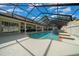Aerial view of the pool featuring a fountain, covered patio, and seating, perfect for relaxing at 2272 Se Laurel Run Dr, Ocala, FL 34471