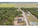 Aerial view of a single story home near a wooded lot and other houses at 23131 Sw Rainelle Rd, Dunnellon, FL 34431