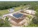 Aerial view of a single story home, wooded surroundings and long driveway at 23131 Sw Rainelle Rd, Dunnellon, FL 34431