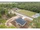 An aerial view of a home with a pool on a large lot, featuring a metal outbuilding and mature landscaping at 23131 Sw Rainelle Rd, Dunnellon, FL 34431