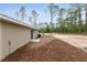 Spacious backyard of a single-story home features lush landscaping and mature trees, creating a private outdoor oasis at 23131 Sw Rainelle Rd, Dunnellon, FL 34431