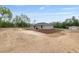 Lush backyard of a single-story home featuring a patio, landscaping, and mature trees, creating a tranquil retreat at 23131 Sw Rainelle Rd, Dunnellon, FL 34431
