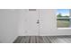 Close-up shot of white front door with modern hardware and flooring at 23131 Sw Rainelle Rd, Dunnellon, FL 34431