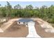 Aerial view of new construction home with long driveway and wooded surroundings at 23131 Sw Rainelle Rd, Dunnellon, FL 34431