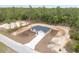 Aerial view of single-story home with a long driveway and attached garage on a spacious lot with lush landscaping and mature trees at 23131 Sw Rainelle Rd, Dunnellon, FL 34431
