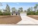 Charming single-story home featuring a spacious front yard and a two-car garage at 23131 Sw Rainelle Rd, Dunnellon, FL 34431