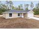 Front exterior of a single-story home with a two-car garage and newly installed landscaping at 23131 Sw Rainelle Rd, Dunnellon, FL 34431