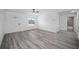 Open concept home with wood-look flooring and view into a bathroom at 23131 Sw Rainelle Rd, Dunnellon, FL 34431