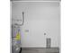 Utility room featuring a new water heater and gray wood-look flooring at 23131 Sw Rainelle Rd, Dunnellon, FL 34431
