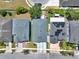 Aerial view of houses showcasing their roofs, driveways, and surrounding greenery in a neighborhood setting at 2525 Sand Arbor Cir, Orlando, FL 32824