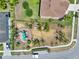 Aerial perspective of a backyard with a play structure, mature landscaping, and a well-manicured lawn at 2525 Sand Arbor Cir, Orlando, FL 32824