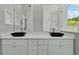 Modern bathroom featuring dual black vessel sinks, white cabinetry, and a bright window view at 2525 Sand Arbor Cir, Orlando, FL 32824
