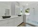 Elegant bathroom with double sinks, quartz counters, and a glass enclosed shower with an arch window at 2525 Sand Arbor Cir, Orlando, FL 32824