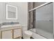 Bathroom featuring stylish gray tiles in the shower and back splash with an illuminated mirror at 2525 Sand Arbor Cir, Orlando, FL 32824