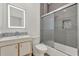 Bathroom featuring stylish gray tiles in the shower and back splash with an illuminated mirror at 2525 Sand Arbor Cir, Orlando, FL 32824