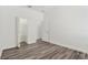 Neutral bedroom showcasing gray wood floors, a closet, and a doorway for easy access at 2525 Sand Arbor Cir, Orlando, FL 32824
