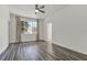Large bedroom with wood floors, a window, and an open doorway, providing a welcoming space at 2525 Sand Arbor Cir, Orlando, FL 32824