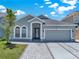 Charming single-story home features a two-car garage and lovely landscaping at 2525 Sand Arbor Cir, Orlando, FL 32824