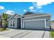 Attractive home features a two-car garage, neat landscaping, and inviting entryway at 2525 Sand Arbor Cir, Orlando, FL 32824
