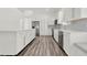 Stylish kitchen featuring white cabinets, stainless appliances, and hardwood floors at 2525 Sand Arbor Cir, Orlando, FL 32824