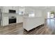 Modern kitchen with stainless steel appliances, white cabinets, and wood-look flooring at 2525 Sand Arbor Cir, Orlando, FL 32824