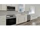 Modern kitchen features stainless steel appliances, gray backsplash, and plenty of storage with white cabinetry at 2525 Sand Arbor Cir, Orlando, FL 32824
