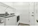 Clean and bright laundry room with a Whirlpool washer and dryer and convenient overhead shelving at 2525 Sand Arbor Cir, Orlando, FL 32824