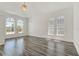 Bright living room with wood floors, arch windows, and modern lighting at 2525 Sand Arbor Cir, Orlando, FL 32824